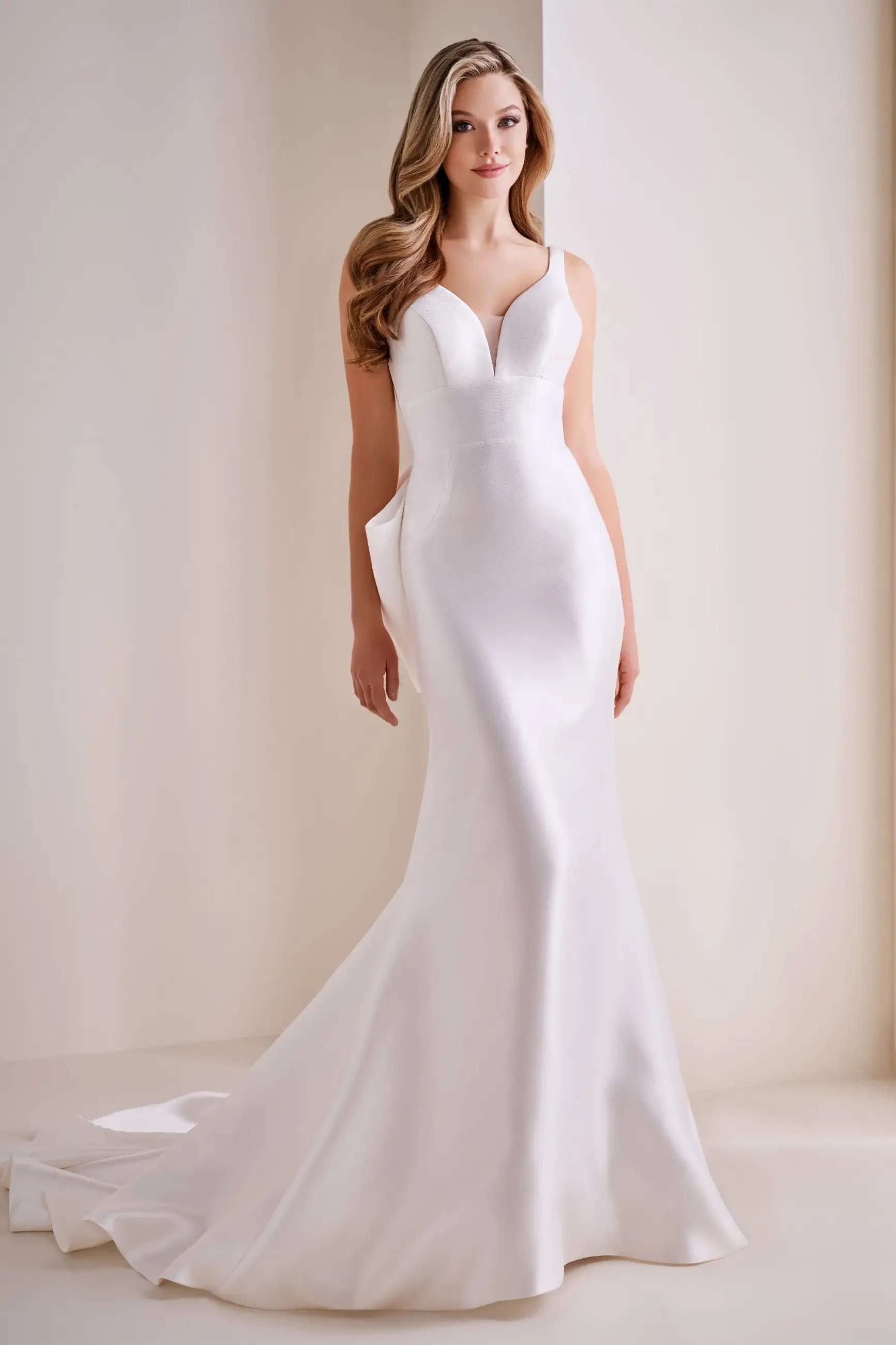 Model is wearing a mikado strapless mermaid bridal gown by enchanting by mon cheri