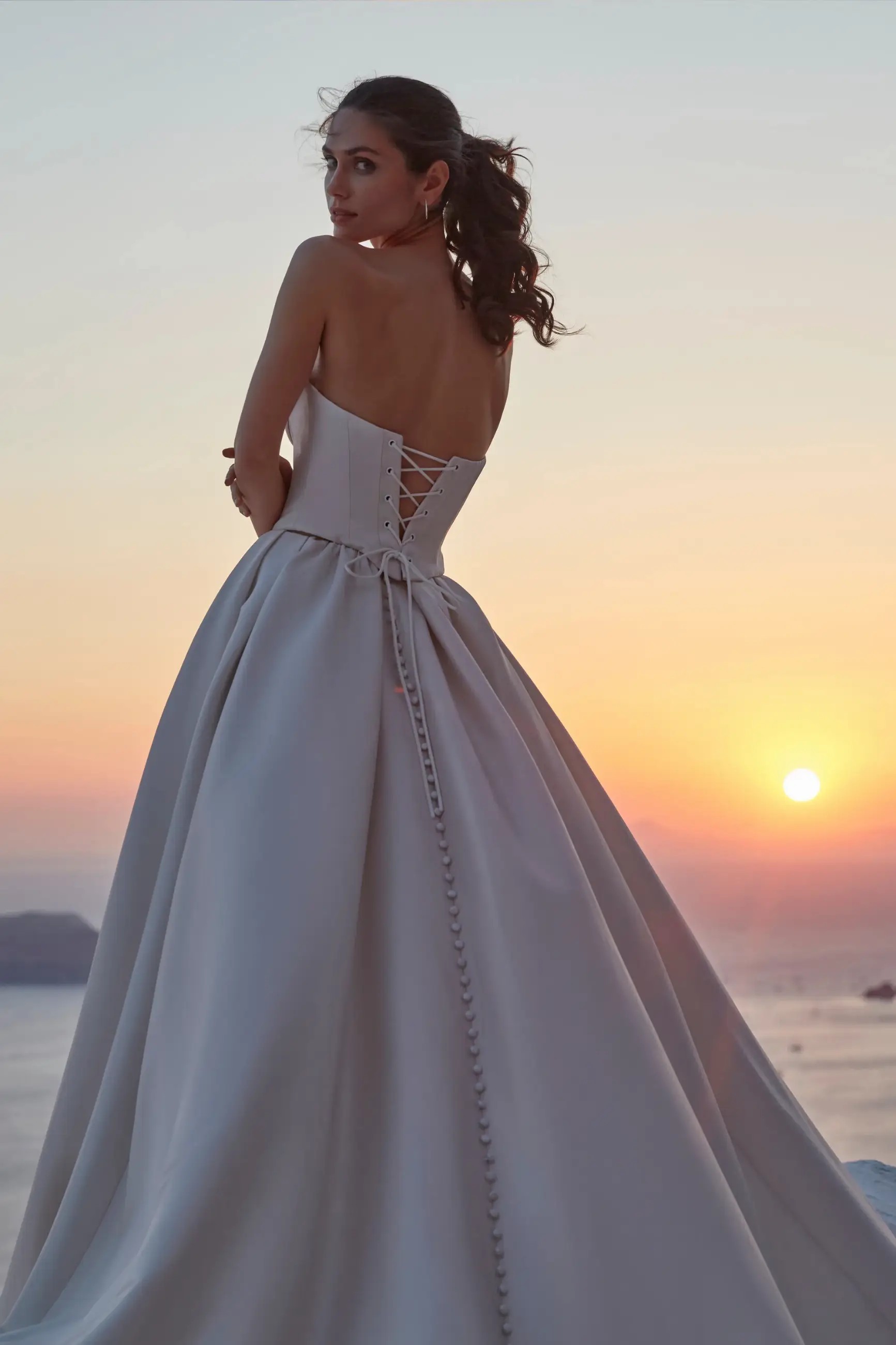 Model is wearing a mikado ball gown wedding dress with a sweetheart neckline by madison james