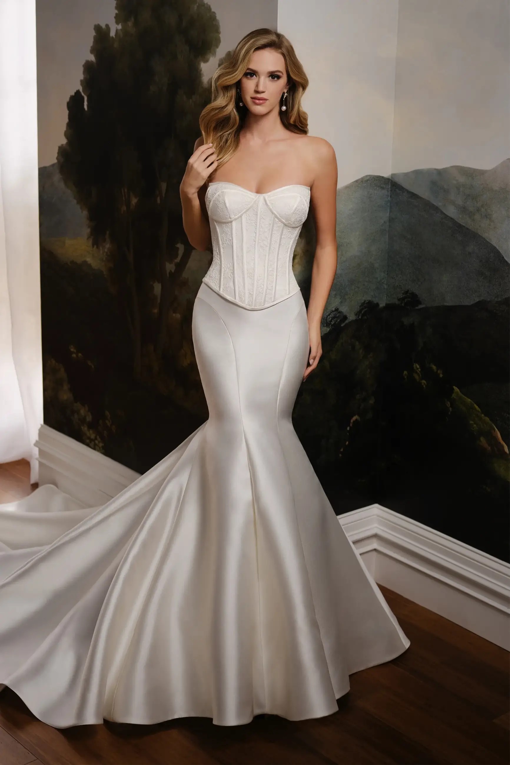 Model is wearing a trumpet wedding dress with a dropped waist, lace bodice, and mikado skirt by martin thornburg