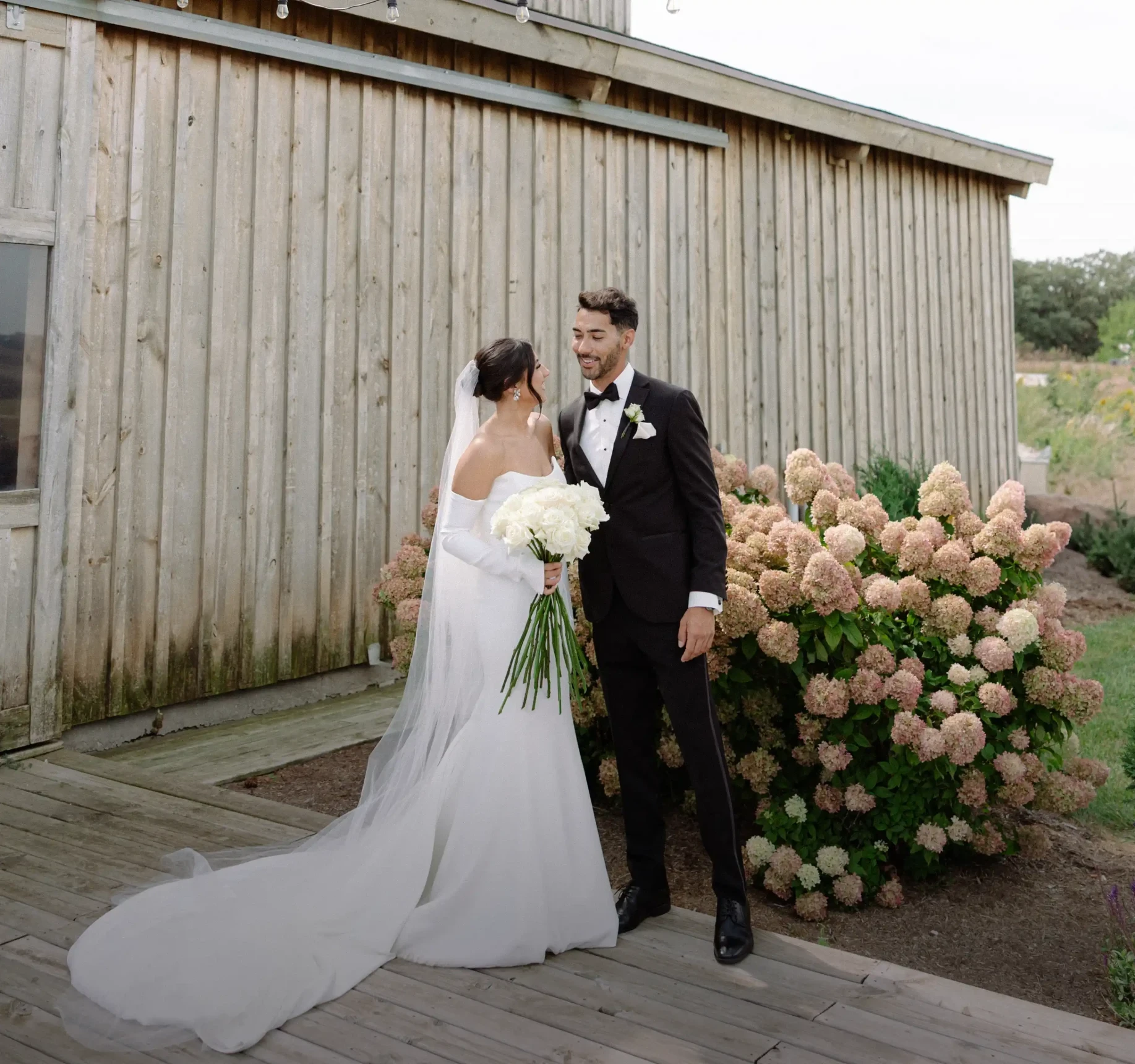 Сouple wearing a white gown and a black suit