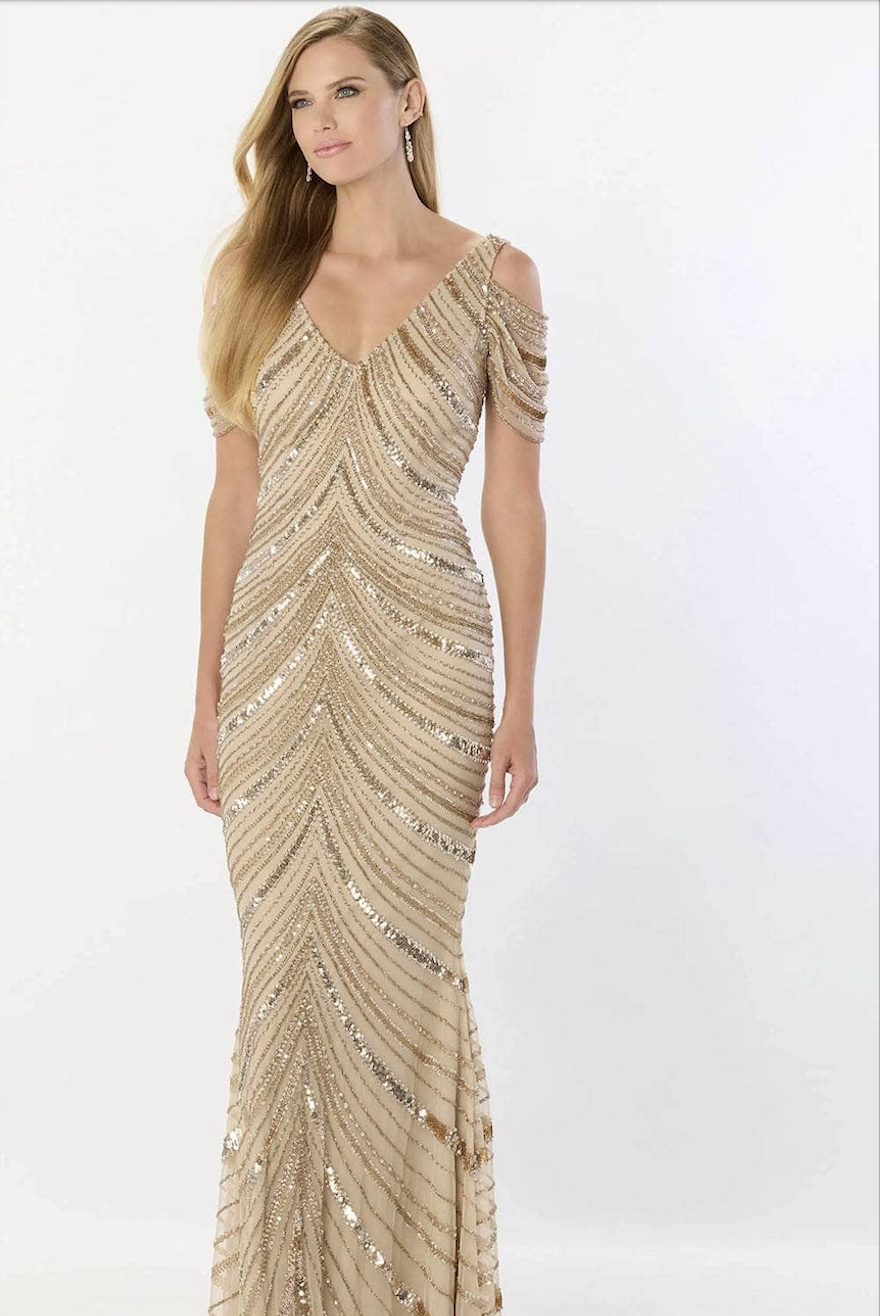 model is wearing a sleeveless champagne mother of the bride dress with detachable sleeves