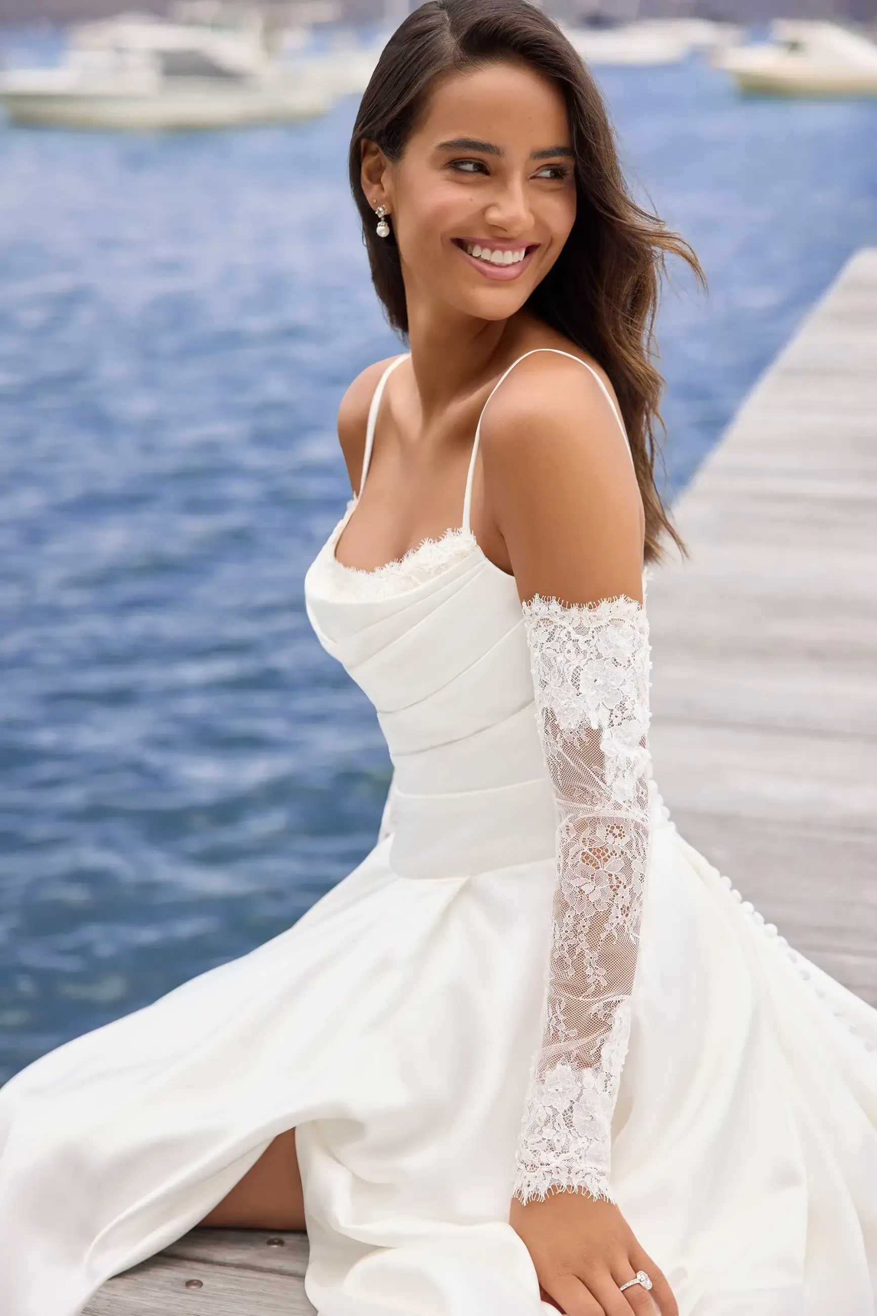 model is wearing an off the shoulder a-line wedding dress
